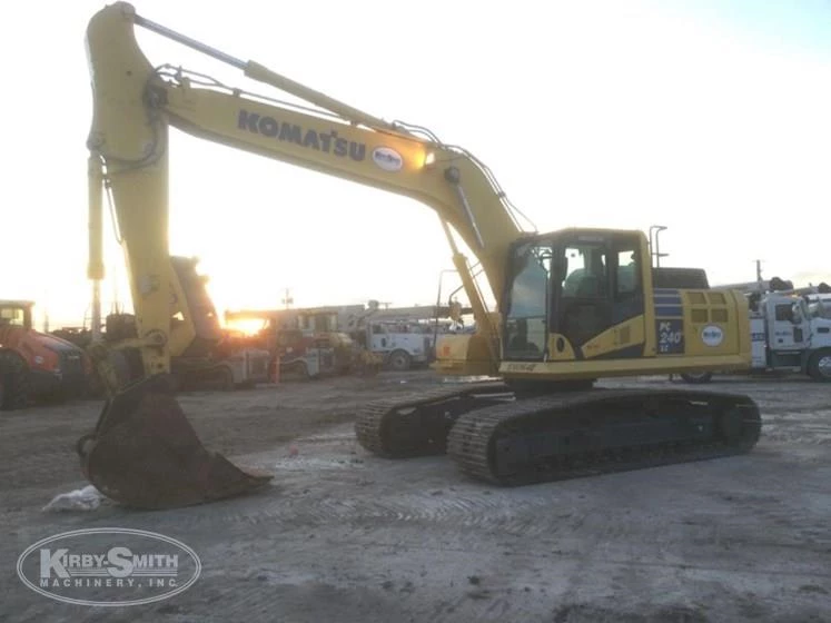 Used Komatsu under cloudy sky